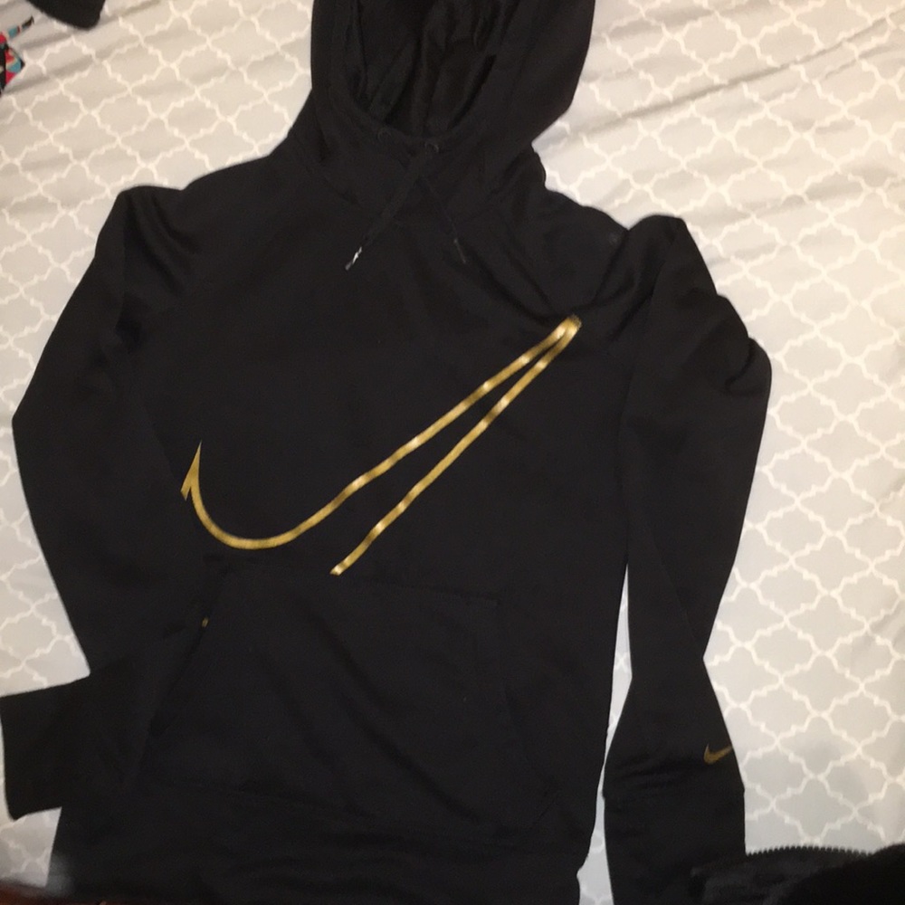 This is a black and gold Nike sweatshirt.
